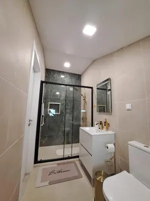 a bathroom with a shower and a toilet and a sink at Estudio Vista Mar in Ribeira Brava