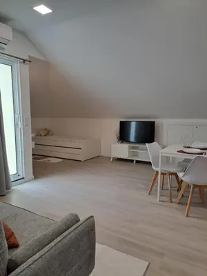 a living room with a couch and a table and a tv at Estudio Vista Mar in Ribeira Brava