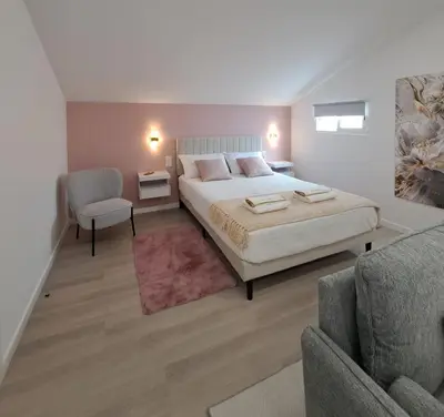 a bedroom with a bed and a chair and a couch at Estudio Vista Mar in Ribeira Brava