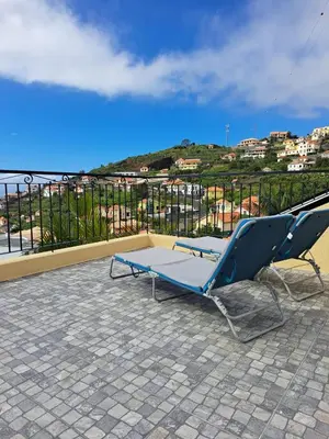 a couple of chairs sitting on top of a roof at Estudio Vista Mar in Ribeira Brava