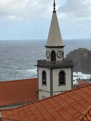 a clock tower on the roof of a building at Casa da Torre in Porto Moniz