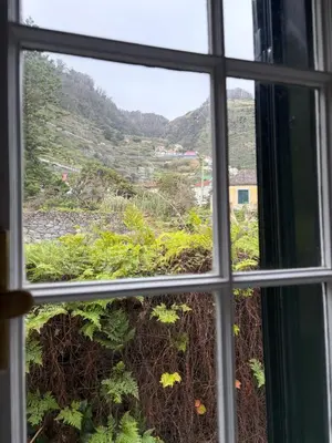 a window with a view of a mountain view at Casa da Torre in Porto Moniz
