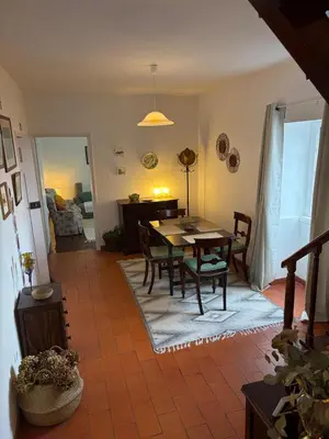 a dining room with a table and chairs in a room at Casa da Torre in Porto Moniz
