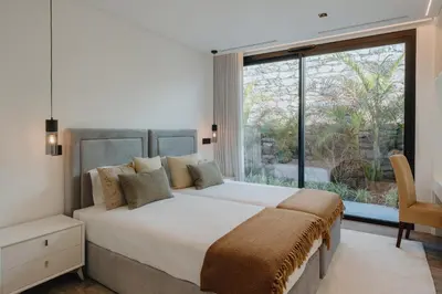 a bedroom with a large bed and a large window at Villa Guindaste II Luxury with Pool & Sea View in Santana