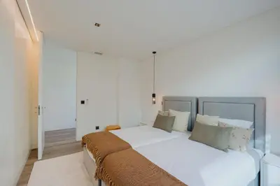 a bedroom with a bed with white sheets and pillows at Villa Guindaste II Luxury with Pool & Sea View in Santana
