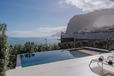 a swimming pool with a view of the ocean at Villa Guindaste II Luxury with Pool & Sea View in Santana