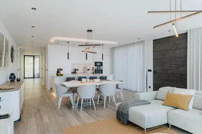 a living room and kitchen with a couch and a table at Villa Guindaste II Luxury with Pool & Sea View in Santana