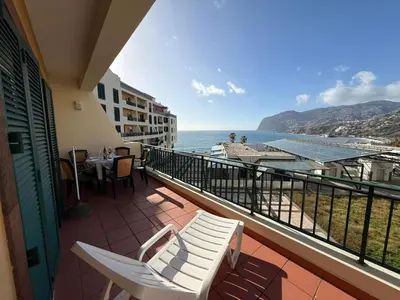 a balcony with chairs and a view of the ocean at Formosa View in Funchal