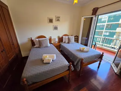 two twin beds in a room with a window at Formosa View in Funchal