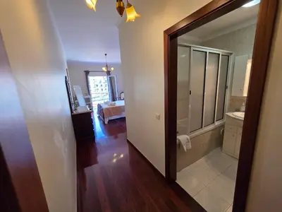 a bathroom with a mirror and a sink in a room at Formosa View in Funchal