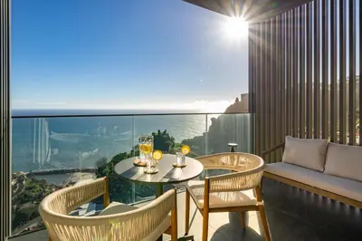 a balcony with a table and chairs with a view at Calheta Hills IV Apartment with Sea View in Calheta