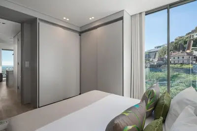 a bedroom with a bed and a large window at Calheta Hills IV Apartment with Sea View in Calheta