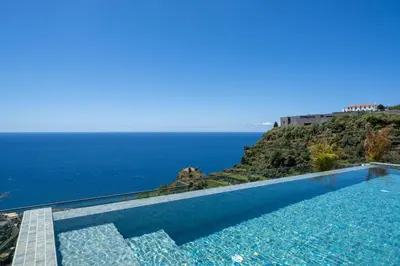 a swimming pool with a view of the ocean at Calheta Hills IV Apartment with Sea View in Calheta