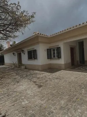 a large white house with black shuttered windows at House Pilar close to Funchal in Funchal
