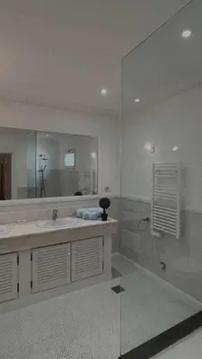 a bathroom with a sink and a tub and a mirror at House Pilar close to Funchal in Funchal
