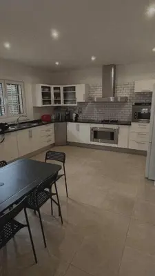 a large kitchen with a table and chairs in it at House Pilar close to Funchal in Funchal
