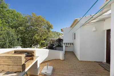 a patio with a table and chairs and a tree at Casa 54 in Valverde