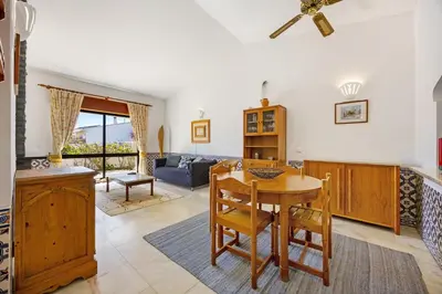 a kitchen with a counter with a refrigerator and two stools at Casa 54 in Valverde