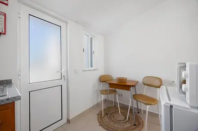 a bedroom with a bed and a couch and a tv at Estúdio Agostinho in Luz