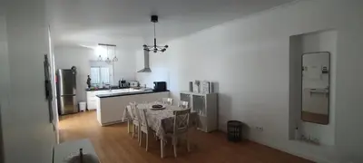 a kitchen with white cabinets and a black counter top at Moradia Girassol Porto Santo in Porto Santo