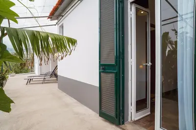 a green door on the side of a house at GuestReady - Funchal Hideaway with BBQ in Funchal