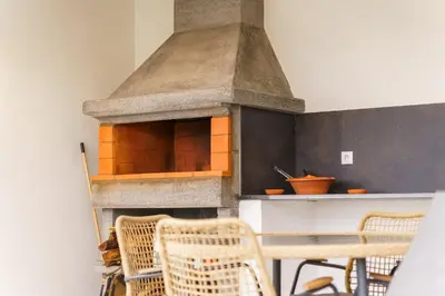 a kitchen with a stone oven with a table and chairs at GuestReady - Funchal Hideaway with BBQ in Funchal
