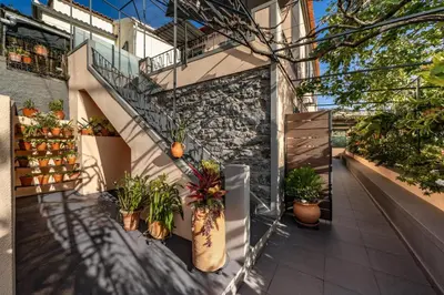a balcony with potted plants on the side of a building at Casa Maria Bela 2-Bedroom with Terrace in Calheta