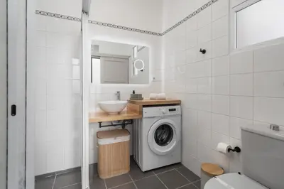 a bathroom with a washing machine and a sink at Casa Maria Bela 2-Bedroom with Terrace in Calheta
