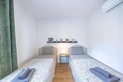 two beds sitting next to each other in a room at Aurea Maris By YOUR KEY MADEIRA in Câmara de Lobos