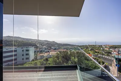 a balcony with a view of a city at Aurea Maris By YOUR KEY MADEIRA in Câmara de Lobos