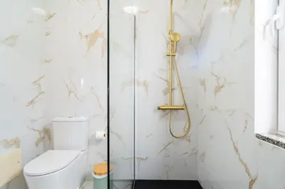 a bathroom with a toilet and a shower at GuestReady - Nature and tranquillity in Madeira in Gaula