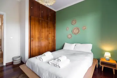 a bedroom with a large bed with towels on it at GuestReady - Nature and tranquillity in Madeira in Gaula