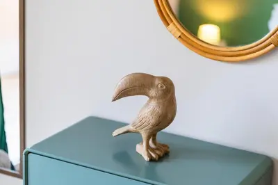 a bird statue sitting on top of a blue dresser at GuestReady - Nature and tranquillity in Madeira in Gaula