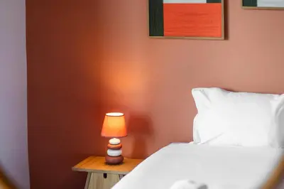 a bedroom with a bed and a lamp on a table at GuestReady - Nature and tranquillity in Madeira in Gaula