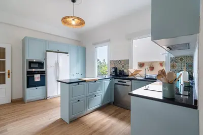 a kitchen with blue cabinets and a counter top at GuestReady - Nature and tranquillity in Madeira in Gaula
