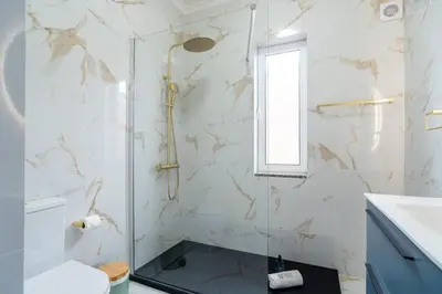 a bathroom with a shower with a glass door at GuestReady - Nature and tranquillity in Madeira in Gaula