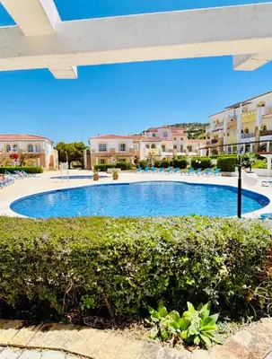 a large swimming pool in front of some buildings at Casa da Areia, Three Bedroom Villa by the Beach in Luz