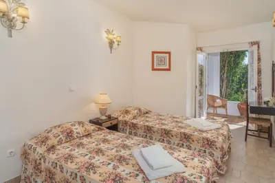 a bedroom with a bed and a couch and a table at Casa da Areia, Three Bedroom Villa by the Beach in Luz
