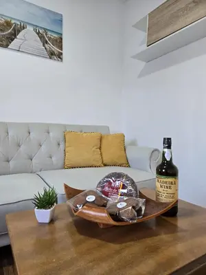 a bottle of wine sitting on a coffee table in a living room at Casa da Avo Belinha in Funchal