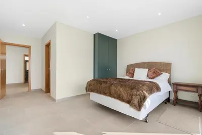 a bedroom with a large bed and a large window at Casa da boa vista in Canhas