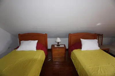 two beds sitting next to each other in a room at !Your Home In Madeira in Funchal