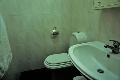 a bathroom with a white toilet and a sink at !Your Home In Madeira in Funchal