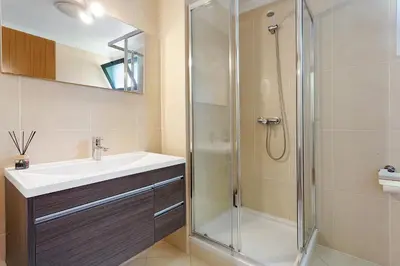a bathroom with a glass shower and a sink at Agostinho Apartment Santa Cruz in Santa Cruz