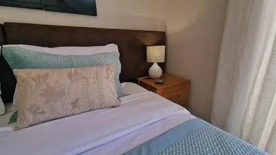 a bedroom with a bed and a lamp on a night stand at Quinta da Atalaia - Seaview Townhouse with pool in Lagos