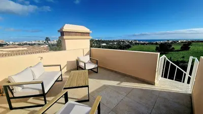 a balcony with chairs and a table on a building at Quinta da Atalaia - Seaview Townhouse with pool in Lagos