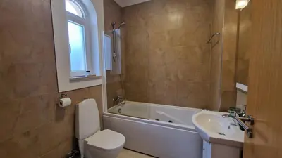 a bathroom with a toilet and a tub and a sink at Quinta da Atalaia - Seaview Townhouse with pool in Lagos