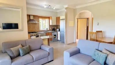 a living room with two couches and a kitchen at Quinta da Atalaia - Seaview Townhouse with pool in Lagos