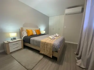 a bedroom with a bed with yellow pillows and a night stand at My little home cottage in Porto Moniz