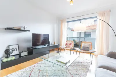 a living room with a couch and a tv at Garajau Comfort Stay by Atlantic Holiday in Caniço