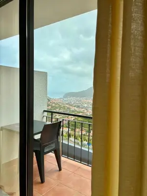 a bedroom with a bed and a desk and a table at Seaside & Levada Escape in Machico